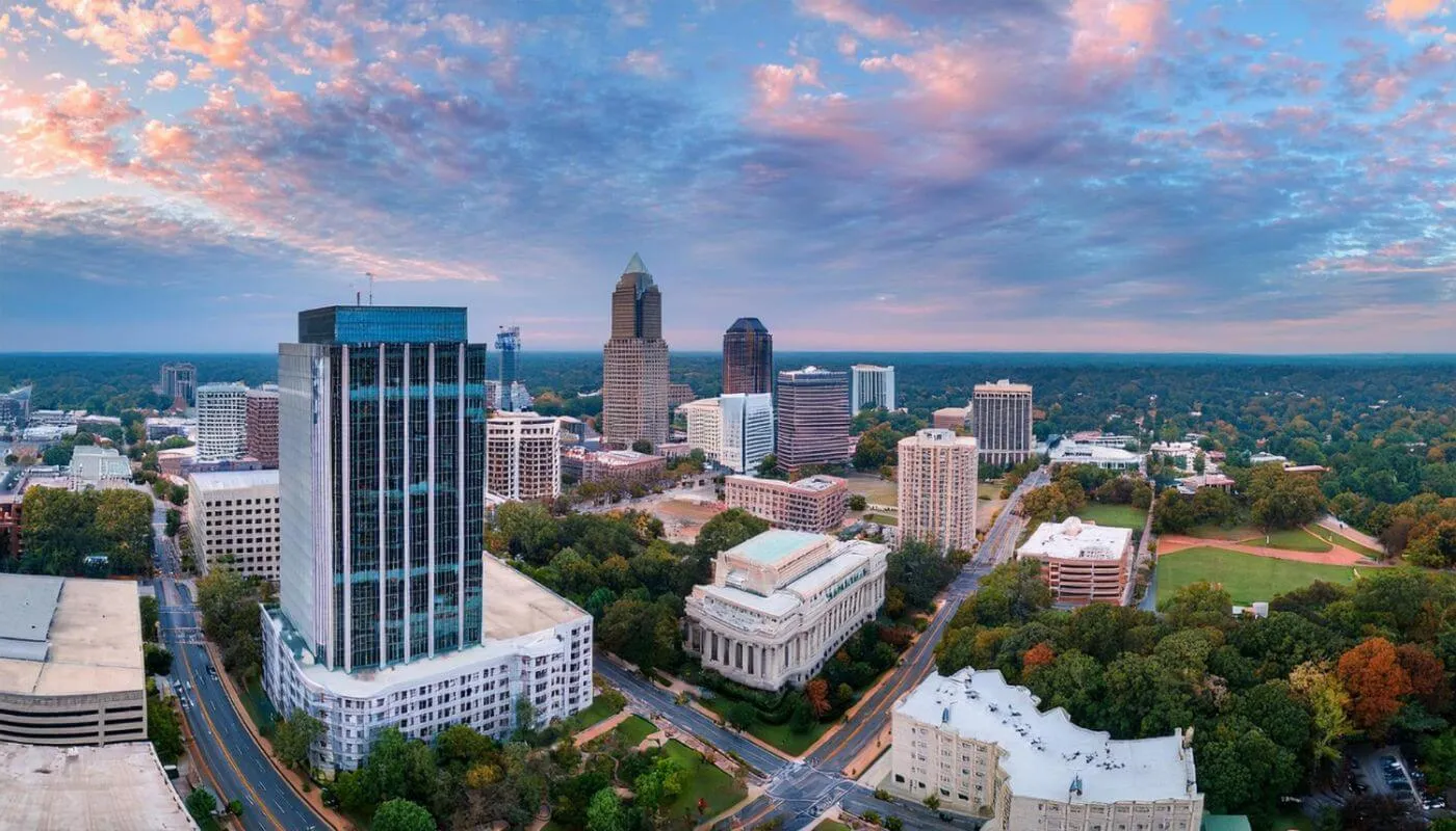 Aerial view of Charlotte, North Carolina, showing EV charger installation, solar panels, battery storage, and panel upgrades