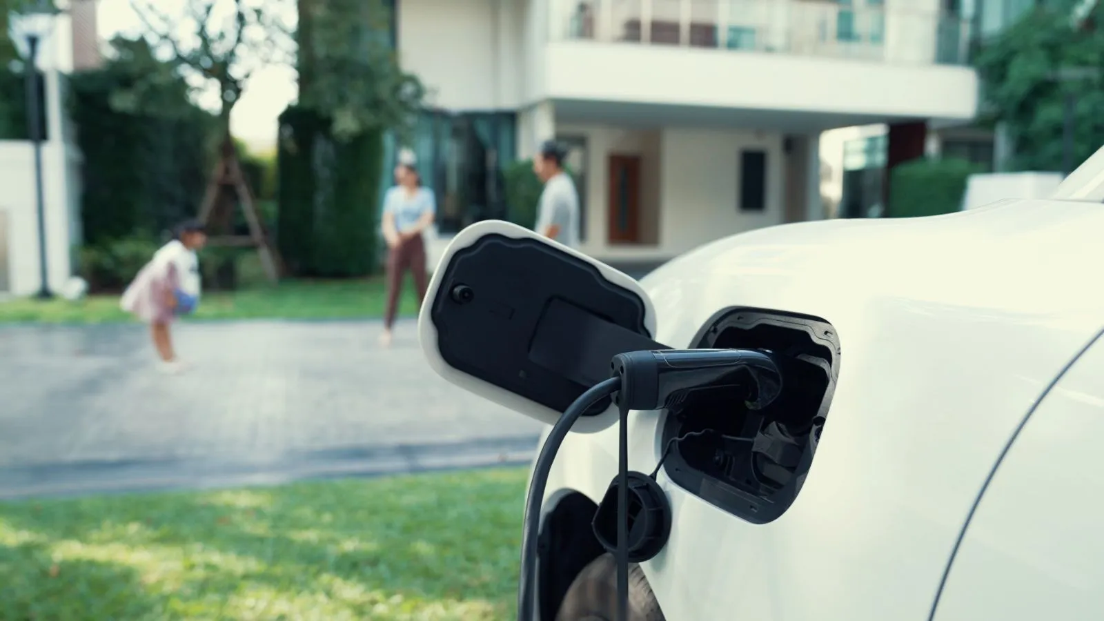 Family charging their EV at home with rooftop solar panels in North Carolina