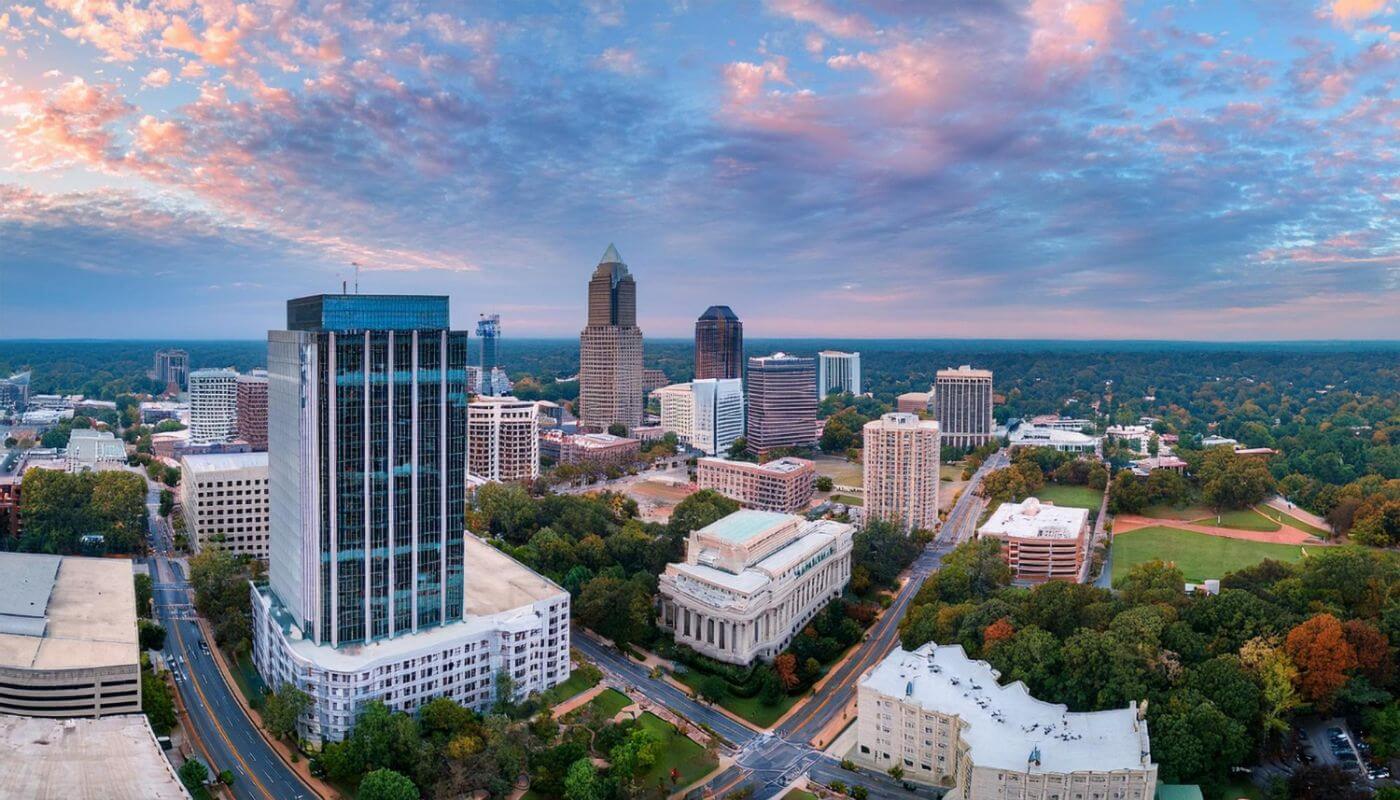 Aerial view of Charlotte, North Carolina, showing EV charger installation, solar panels, battery storage, and panel upgrades